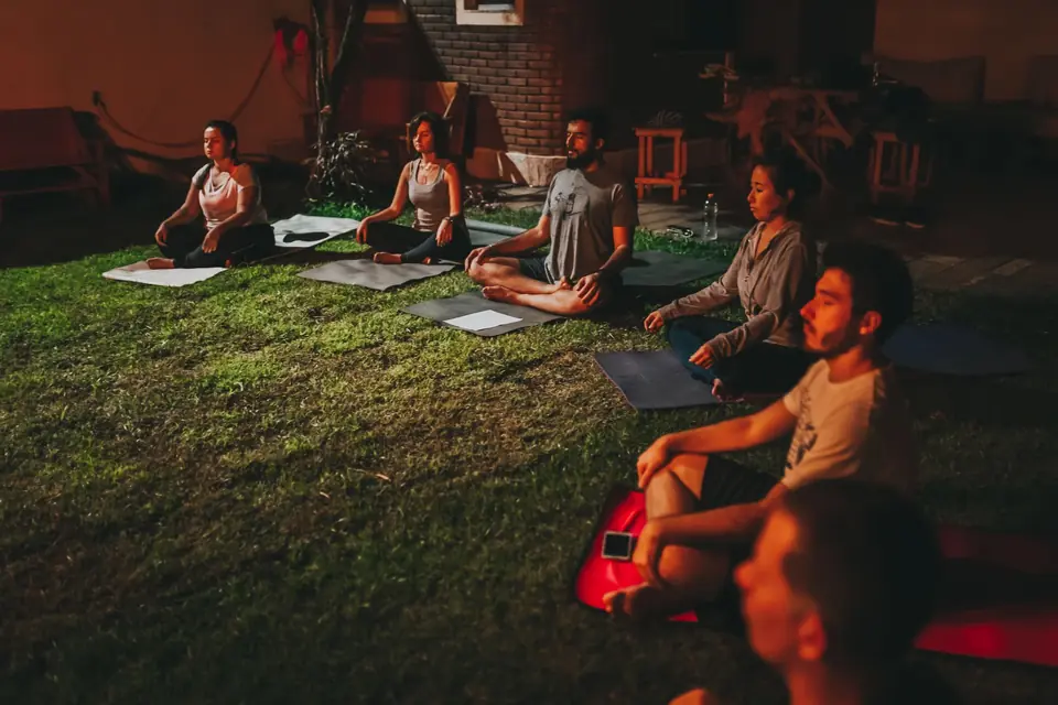 A group practising outdoors together in the evening